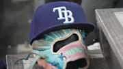 Sep 26, 2025; Toronto, Ontario, CAN; The hat and glove of Tampa Bay Rays third baseman Junior Caminero (13) in the dugout during the game against the Toronto Blue Jays at Rogers Centre. 