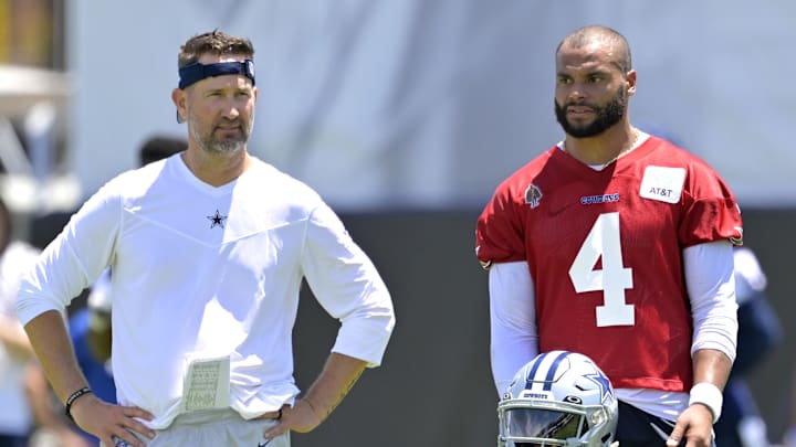 Dallas Cowboys offensive coordinator Brian Schottenheimer and quarterback Dak Prescott watch training camp.