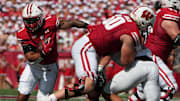 Sep 2, 2023; Madison, WI, USA; Wisconsin Badgers running back Chez Mellusi (1) runs behind offensive lineman Joe Huber (60) against the Buffalo Bulls during the first quarter at Camp Randall Stadium.
