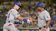 Aug 29, 2025; West Sacramento, California, USA; Texas Rangers outfielder Michael Helman (24) high fives third base coach Tony Beasley (27) after hitting a home run against the Athletics during the seventh inning at Sutter Health Park. 