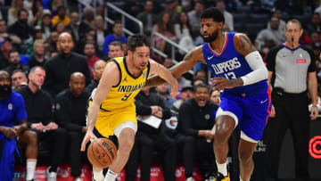 Mar 25, 2024; Los Angeles, California, USA; Indiana Pacers guard T.J. McConnell (9) moves the ball against Los Angeles Clippers forward Paul George (13) during the first half at Crypto.com Arena. Mandatory Credit: Gary A. Vasquez-USA TODAY Sports