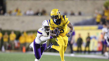 Sep 7, 2024; Morgantown, West Virginia, USA; West Virginia Mountaineers wide receiver Jaden Bray (5) catches a pass and runs for extra yards during the third quarter against the Albany Great Danes at Mountaineer Field at Milan Puskar Stadium. Mandatory Credit: Ben Queen-Imagn Images