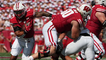 Sep 2, 2023; Madison, WI, USA; Wisconsin Badgers running back Chez Mellusi (1) runs behind offensive lineman Joe Huber (60) against the Buffalo Bulls during the first quarter at Camp Randall Stadium.