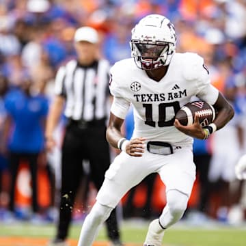 Sep 14, 2024; Gainesville, Florida, USA; Texas A&M Aggies quarterback Marcel Reed (10) runs with the ball against the Florida Gators during the first half at Ben Hill Griffin Stadium. Mandatory Credit: Matt Pendleton-Imagn Images