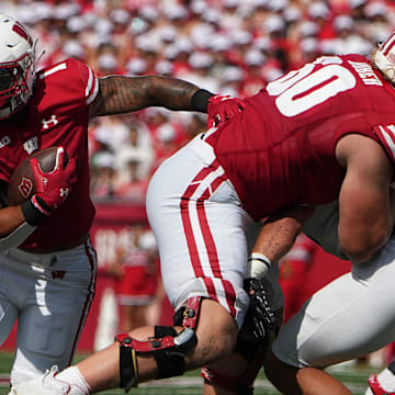 Sep 2, 2023; Madison, WI, USA; Wisconsin Badgers running back Chez Mellusi (1) runs behind offensive lineman Joe Huber (60) against the Buffalo Bulls during the first quarter at Camp Randall Stadium.