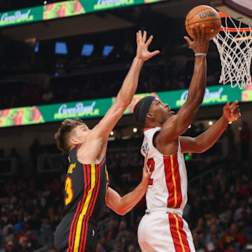 Apr 9, 2024; Atlanta, Georgia, USA; Miami Heat forward Jimmy Butler (22) shoots past Atlanta Hawks guard Bogdan Bogdanovic (13) in the first quarter at State Farm Arena. Mandatory Credit: Brett Davis-Imagn Images