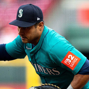 Seattle Mariners first baseman Donovan Solano waives off the pitcher before getting Cincinnati Reds outfielder Jake Fraley (27) out at first in the second inning of the MLB game between Cincinnati Reds and Seattle Mariners at at Great American Ball Park on April 15.