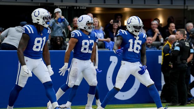 Colts receiver Ashton Dulin (blue jersey; white pants) celebrates with teammates after scoring a touchdown. 