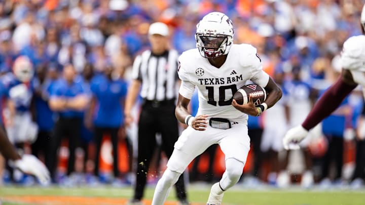 Sep 14, 2024; Gainesville, Florida, USA; Texas A&M Aggies quarterback Marcel Reed (10) runs with the ball against the Florida Gators during the first half at Ben Hill Griffin Stadium. Mandatory Credit: Matt Pendleton-Imagn Images