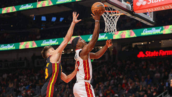 Apr 9, 2024; Atlanta, Georgia, USA; Miami Heat forward Jimmy Butler (22) shoots past Atlanta Hawks guard Bogdan Bogdanovic (13) in the first quarter at State Farm Arena. Mandatory Credit: Brett Davis-Imagn Images