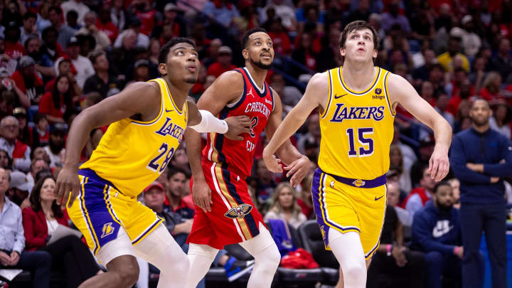 Apr 16, 2024; New Orleans, Louisiana, USA; New Orleans Pelicans guard CJ McCollum (3) is guarded from a free throw by Los Angeles Lakers guard Austin Reaves (15) and forward Rui Hachimura (28) during the first half of a play-in game of the 2024 NBA playoffs at Smoothie King Center. Mandatory Credit: Stephen Lew-USA TODAY Sports