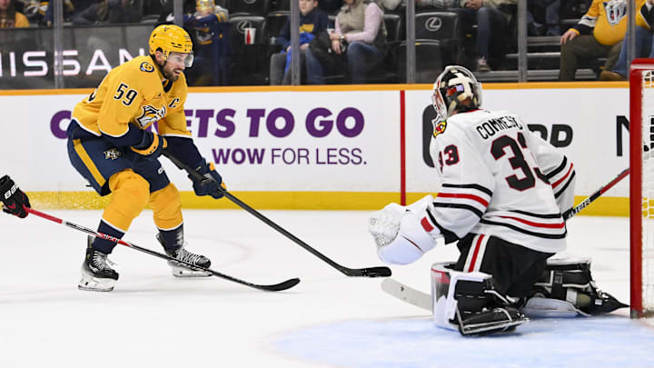 Jan 10, 2026; Nashville, Tennessee, USA;  Chicago Blackhawks goaltender Drew Commesso (33) blocks the shot of Nashville Predators defenseman Roman Josi (59) during the third period at Bridgestone Arena. Mandatory Credit: Steve Roberts-Imagn Images