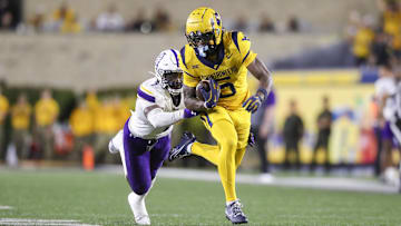 Sep 7, 2024; Morgantown, West Virginia, USA; West Virginia Mountaineers wide receiver Jaden Bray (5) catches a pass and runs for extra yards during the third quarter against the Albany Great Danes at Mountaineer Field at Milan Puskar Stadium. Mandatory Credit: Ben Queen-Imagn Images