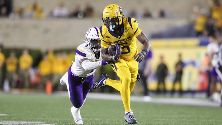 Sep 7, 2024; Morgantown, West Virginia, USA; West Virginia Mountaineers wide receiver Jaden Bray (5) catches a pass and runs for extra yards during the third quarter against the Albany Great Danes at Mountaineer Field at Milan Puskar Stadium. Mandatory Credit: Ben Queen-Imagn Images