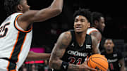 Bearcats Dillon Mitchell (23) looks for a shot during Game 1 of the 2025 Phillips 66 Big 12 Basketball Championship against the Oklahoma State Cowboys at the T-Mobile Center in Kansas City, Missouri on Tuesday March 11, 2025. Bearcats lead the game at halftime with a score of 38-26.