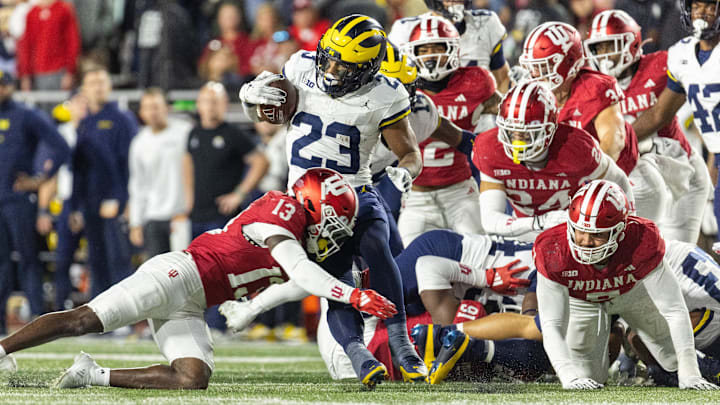 Michigan Wolverines running back Jordan Marshall (23) runs with the ball while Indiana Hoosiers defensive back Cedarius Doss (13) defends in the second half at Memorial Stadium. Michigan Wolverines running back Jordan Marshall (23) runs with the ball while Indiana Hoosiers defensive back Cedarius Doss (13) defends in the second half at Memorial Stadium.