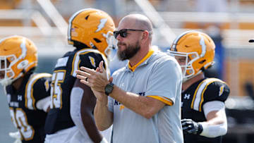 Kent State interim coach Mark Carney watches his team through warmups before a game against Buffalo on Sept. 13, 2025, in Kent.