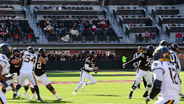 Nov 30, 2024; Lubbock, Texas, USA;  Texas Tech Red Raiders quarterback Behren Morton (2) scrambles against the West Virginia Mountaineers defensive in the first half at Jones AT&T Stadium and Cody Campbell Field. Mandatory Credit: Michael C. Johnson-Imagn Images