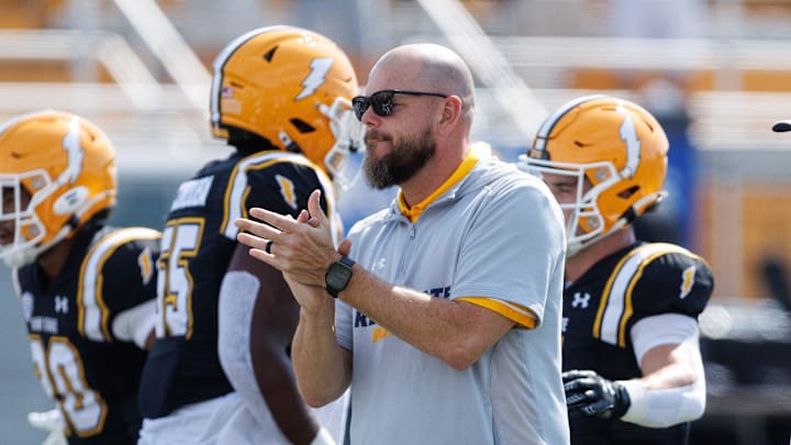 Kent State interim coach Mark Carney watches his team through warmups before a game against Buffalo on Sept. 13, 2025, in Kent.