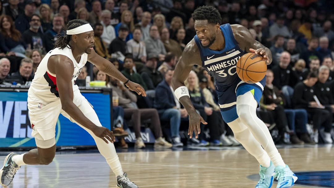 Feb 11, 2026; Minneapolis, Minnesota, USA; Minnesota Timberwolves forward Julius Randle (30) dribbles the ball as Portland Trail Blazers guard Jrue Holiday (5) in the second half at Target Center.