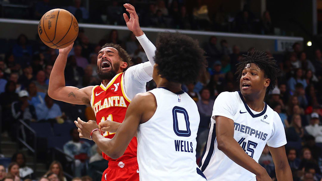 Mar 3, 2025; Memphis, Tennessee, USA; Atlanta Hawks guard Trae Young (11) reacts as he is fouled by Memphis Grizzlies forward GG Jackson II (45) during the second quarter at FedExForum. Mandatory Credit: Petre Thomas-Imagn Images