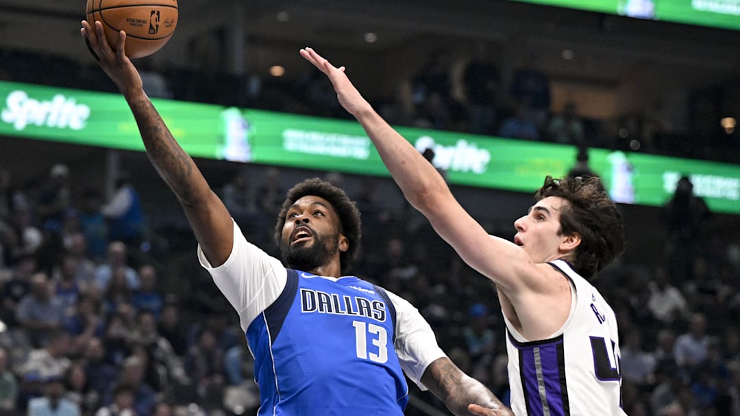 Feb 26, 2026; Dallas, Texas, USA; Dallas Mavericks forward Naji Marshall (13) drives to the basket past Sacramento Kings center Maxime Raynaud (42) during the first quarter at the American Airlines Center. Mandatory Credit: Jerome Miron-Imagn Images
