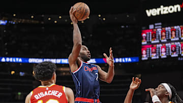 Mar 14, 2025; Atlanta, Georgia, USA; LA Clippers forward Kawhi Leonard (2) shoots between Atlanta Hawks forward Zaccharie Risacher (10) and guard Terance Mann (14) during the second half at State Farm Arena. Mandatory Credit: Dale Zanine-Imagn Images