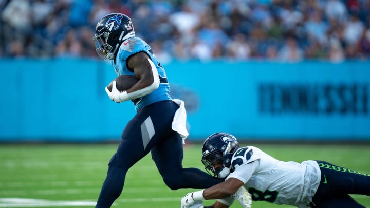 Tennessee Titans running back Julius Chestnut (36) breaks the tackle of Seattle Seahawks cornerback Coby Bryant (8) during their game at Nissan Stadium in Nashville, Tenn., Saturday, Aug. 17, 2024.