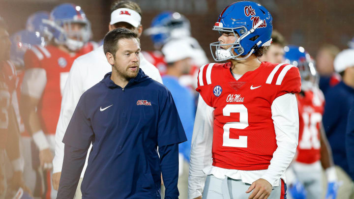 Oct 28, 2023; Oxford, Mississippi, USA; Mississippi Rebels offensive coordinator Charlie Weis Jr. (left) talks with quarterback Jaxson Dart (2) during warm ups prior to the game against the Vanderbilt Commodores at Vaught-Hemingway Stadium. Mandatory Credit: Petre Thomas-USA TODAY Sports