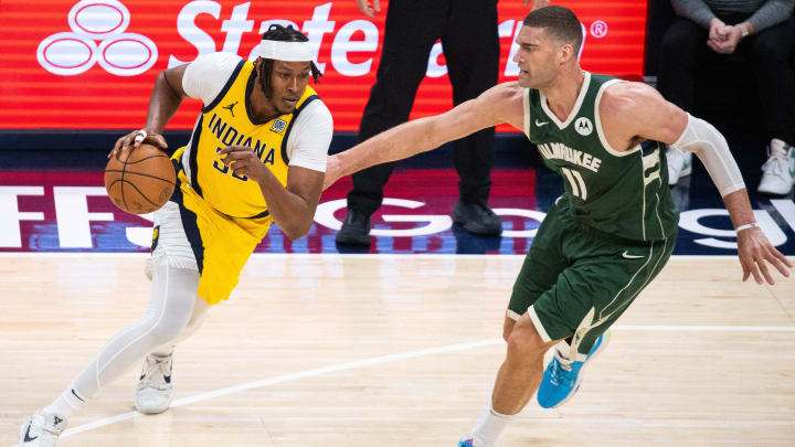 Indiana Pacers center Myles Turner (33) dribbles the ball while Milwaukee Bucks center Brook Lopez (11) defends during game four of the first round for the 2024 NBA playoffs at Gainbridge Fieldhouse. 