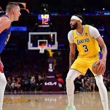 Apr 25, 2024; Los Angeles, California, USA; Los Angeles Lakers forward Anthony Davis (3) controls the ball against Denver Nuggets center Nikola Jokic (15) during the second half in game three of the first round for the 2024 NBA playoffs at Crypto.com Arena. Mandatory Credit: Gary A. Vasquez-Imagn Images