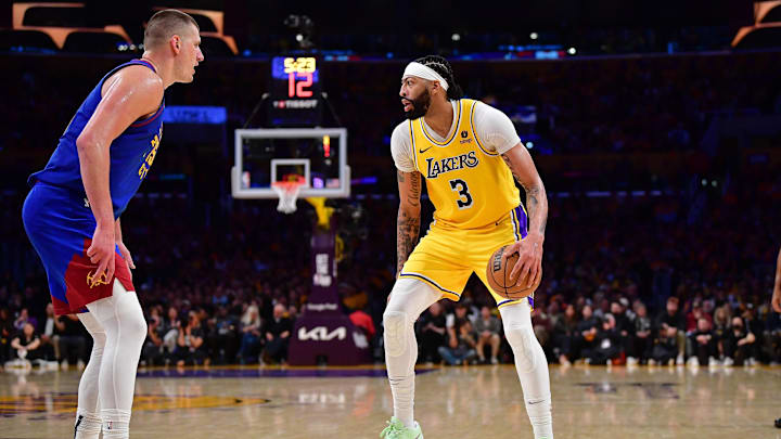 Apr 25, 2024; Los Angeles, California, USA; Los Angeles Lakers forward Anthony Davis (3) controls the ball against Denver Nuggets center Nikola Jokic (15) during the second half in game three of the first round for the 2024 NBA playoffs at Crypto.com Arena. Mandatory Credit: Gary A. Vasquez-Imagn Images