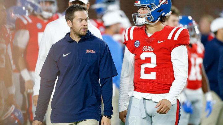 Oct 28, 2023; Oxford, Mississippi, USA; Mississippi Rebels offensive coordinator Charlie Weis Jr. (left) talks with quarterback Jaxson Dart (2) during warm ups prior to the game against the Vanderbilt Commodores at Vaught-Hemingway Stadium. Mandatory Credit: Petre Thomas-USA TODAY Sports