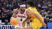 Mar 21, 2024; Salt Lake City, UT, USA;  Arizona Wildcats guard Kylan Boswell (4) drives past Long Beach State 49ers guard AJ George (10) during the second half in the first round of the 2024 NCAA Tournament at Vivint Smart Home Arena-Delta Center. Mandatory Credit: Rob Gray-Imagn Images