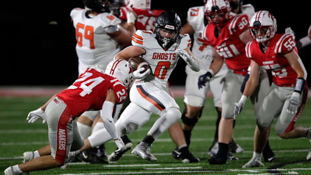 Wisconsin high school football: Kaukauna running back Aiden Reardon (0) attempts to elude a tackle in a game versus Kimberly.
