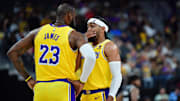 Oct 9, 2023; Las Vegas, Nevada, USA; Los Angeles Lakers forward LeBron James (23) speaks with guard Gabe Vincent (7) during the first half at T-Mobile Arena. Mandatory Credit: Gary A. Vasquez-Imagn Images