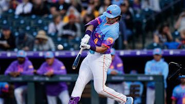 May 9, 2025; Denver, Colorado, USA; Colorado Rockies first baseman Michael Toglia (4) hits a solo home run in the fourth inning against the San Diego Padres at Coors Field. Mandatory Credit: Isaiah J. Downing-Imagn Images