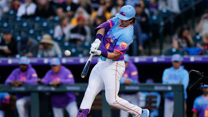 May 9, 2025; Denver, Colorado, USA; Colorado Rockies first baseman Michael Toglia (4) hits a solo home run in the fourth inning against the San Diego Padres at Coors Field. Mandatory Credit: Isaiah J. Downing-Imagn Images