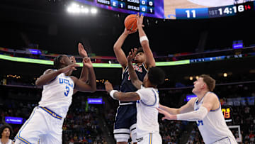 Nov 14, 2025; Inglewood, California, USA;  Arizona Wildcats forward Koa Peat (10) shoots the ball over UCLA Bruins forward Eric Dailey Jr. (3) during the first half of the Hall of Fame Series game at Intuit Dome. Mandatory Credit: Kiyoshi Mio-Imagn Images