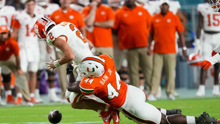 Oct 21, 2023; Miami Gardens, Florida, USA; Miami Hurricanes defensive lineman Rueben Bain Jr. (44) sacks Clemson Tigers quarterback Cade Klubnik (2) during the second quarter at Hard Rock Stadium. Mandatory Credit: Rich Storry-USA TODAY Sports