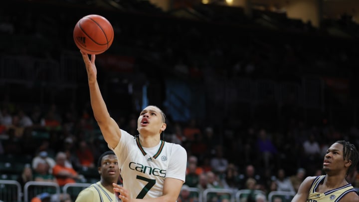 Feb 24, 2024; Coral Gables, Florida, USA; Miami Hurricanes guard Kyshawn George (7) drives to the basket past Georgia Tech Yellow Jackets guard Miles Kelly (13) during the second half at Watsco Center. Mandatory Credit: Sam Navarro-USA TODAY Sports