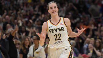 May 24, 2024; Los Angeles, California, USA;  Indiana Fever guard Caitlin Clark (22) smiles as she heads down court after a 3-point basket in the final seconds of the game against the Los Angeles Sparks at Crypto.com Arena. Mandatory Credit: Jayne Kamin-Oncea-USA TODAY Sports