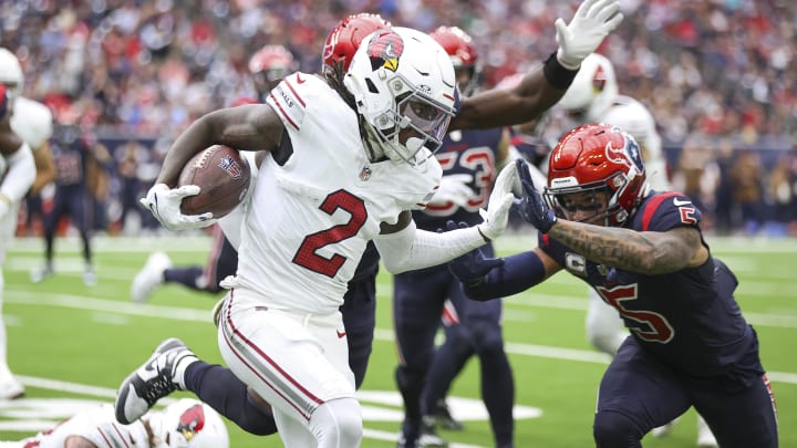 Nov 19, 2023; Houston, Texas, USA; Arizona Cardinals wide receiver Marquise Brown (2) runs with the ball as Houston Texans safety Jalen Pitre (5) attempts to make a tackle during the second quarter at NRG Stadium. Mandatory Credit: Troy Taormina-USA TODAY Sports