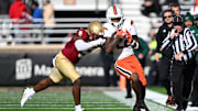 Nov 24, 2023; Chestnut Hill, Massachusetts, USA; Miami Hurricanes running back Mark Fletcher Jr. (22) runs against Boston College Eagles linebacker Kam Arnold (5) during the first half at Alumni Stadium. Mandatory Credit: Brian Fluharty-Imagn Images
