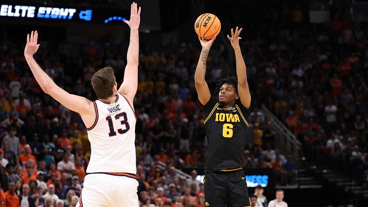 Mar 28, 2026; Houston, TX, USA; Iowa Hawkeyes guard Tavion Banks (6) shoots against Illinois Fighting Illini center Tomislav Ivisic (13) in the second half during an Elite Eight game of the South Regional of the men's 2026 NCAA Tournament at Toyota Center. Mandatory Credit: Troy Taormina-Imagn Images