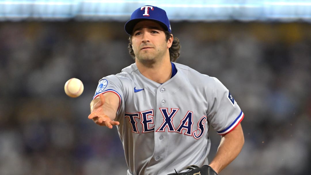 Texas Rangers shortstop Josh Smith (8) tosses to first base for an out. 