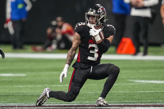 Atlanta Falcons defensive back Jessie Bates III runs after getting an interception in an NFL game.