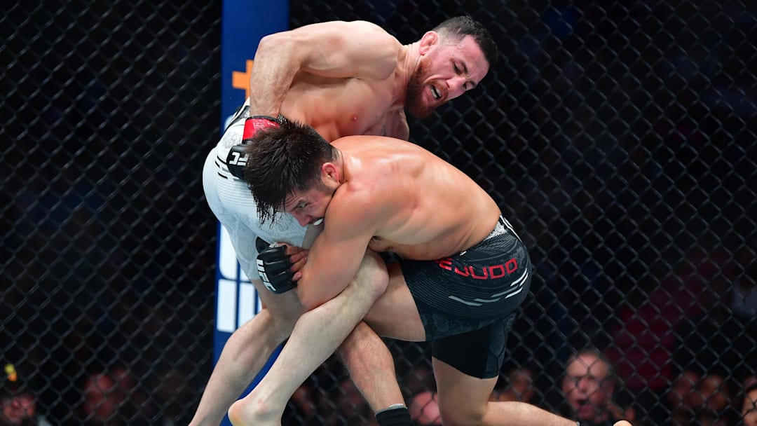 Henry Cejudo applies a hold against Merab Dvalishvili