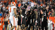 Louisville Cardinals quarterback Miller Moss (7) huddles with his offensive line late in the fourth quarter against Clemson during the Cards 20-19 loss at L&N Stadium in Louisville, Kentucky Friday, Nov. 14, 2025.