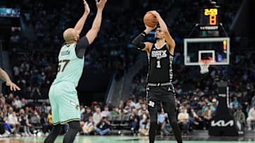 Feb 7, 2025; Charlotte, North Carolina, USA; San Antonio Spurs center Victor Wembanyama (1) shoots a three against Charlotte Hornets forward Taj Gibson (67) during the second half at Spectrum Center. Mandatory Credit: Jim Dedmon-Imagn Images